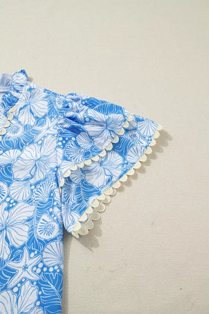 Blue and white tropical floral print blouse with frill sleeves and trim