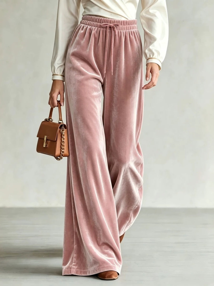 wide-leg pants in blush pink featuring drawstring waist and flared fit
