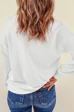 White crewneck sweatshirt with long sleeves, casual fit, paired with blue jeans.