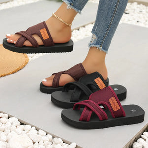 Cross-strap sporty slides in brown, black, and deep purple with branding detail.