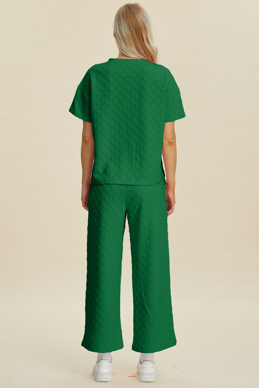 Dark green textured knit lounge set with wide leg pants and short sleeve top.