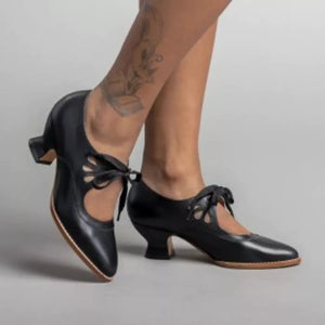 Black leather Mary Jane heels with cutouts and ribbon ties