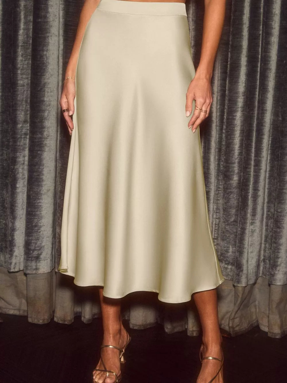 Elegant flowing satin midi skirt in khaki with an a-line cut.