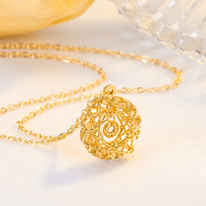 Gold plated sterling pendant necklace with a spherical cage design and delicate chain.