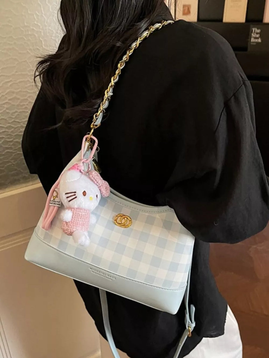 Pastel blue plaid shoulder bag with gold chain accent and Hello Kitty charm