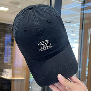 Black baseball cap with white DEISLE logo embroidery and adjustable strap