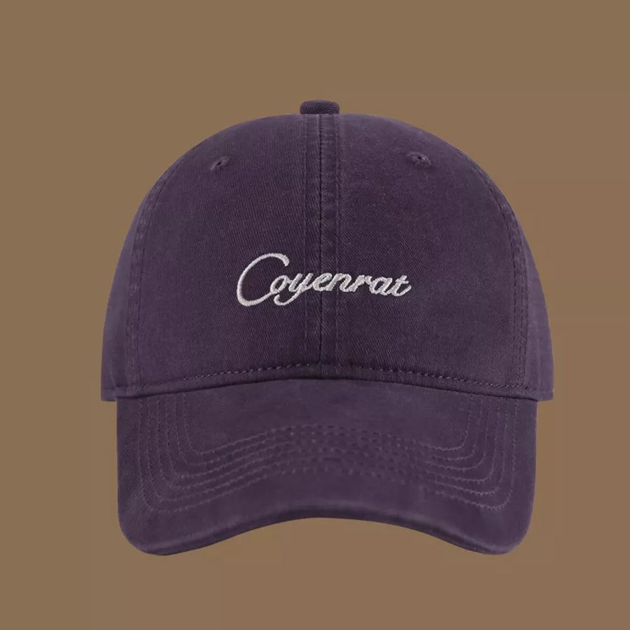 Purple cotton baseball cap with white embroidered text and curved brim