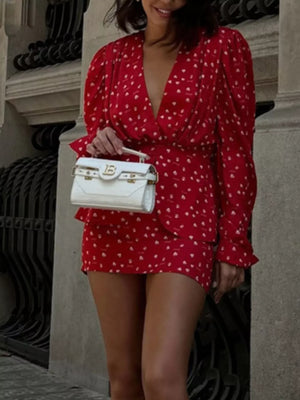 Red heart print mini dress with V-neck, long puff sleeves, and ruffled hem.