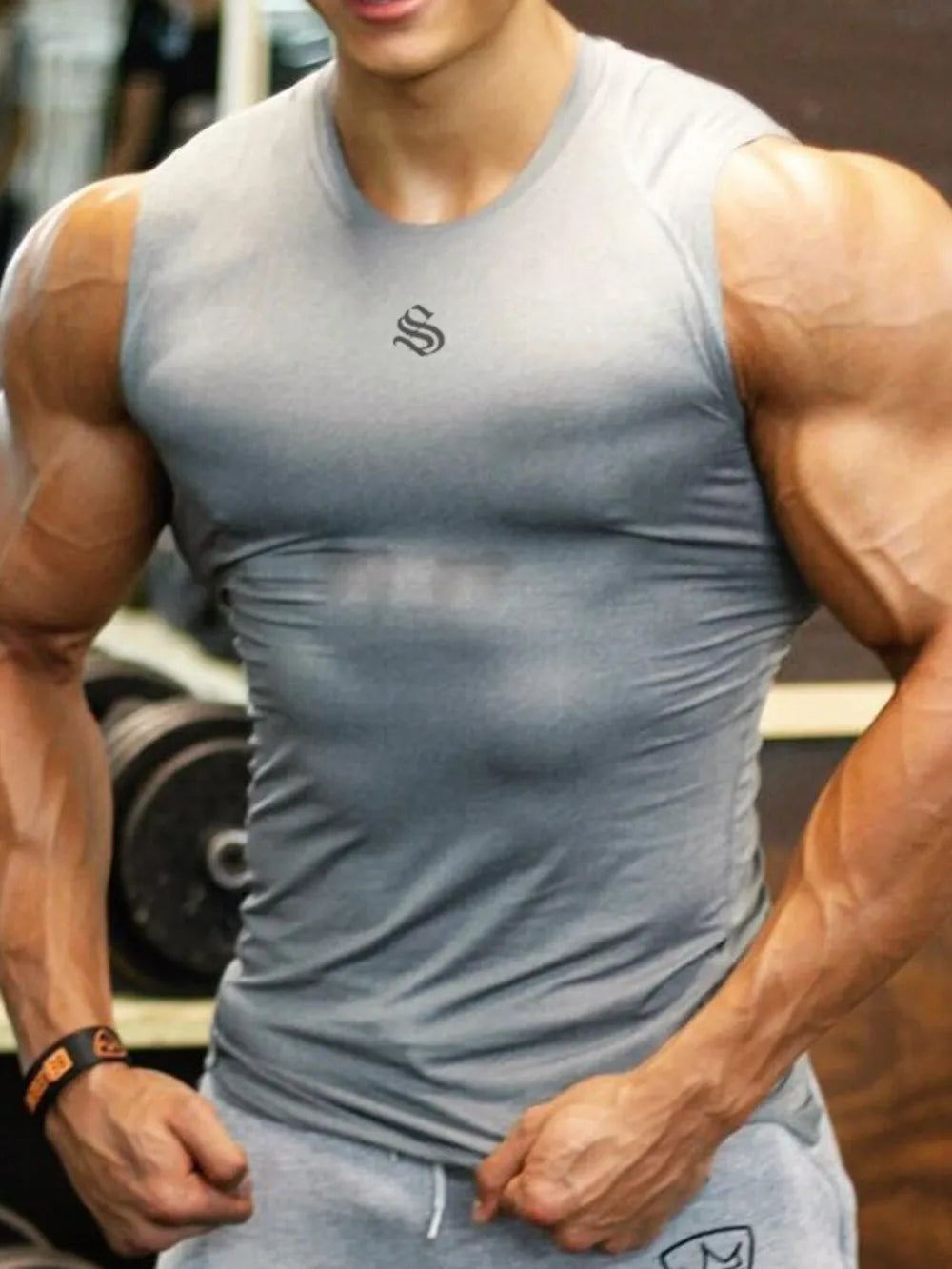 Performance Fit Muscle Tank in gray with a black logo detail on the chest.