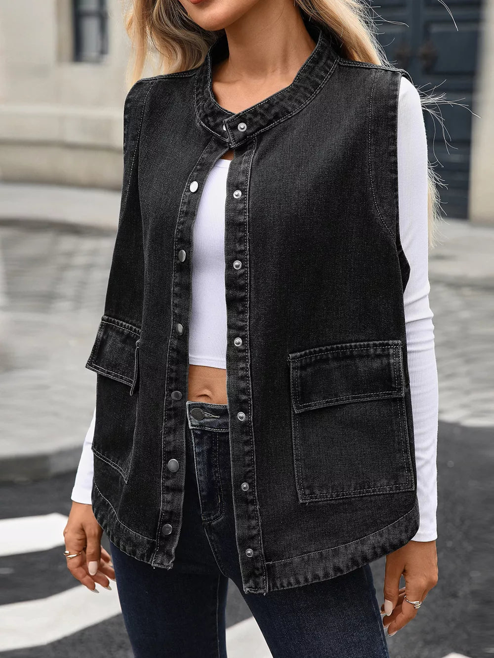 Black washed denim vest with band collar, button front, and chest pockets.