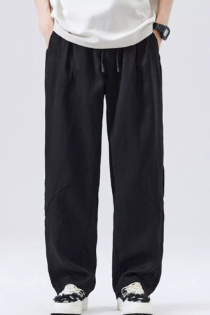 Black loose fit drawstring casual pants with a relaxed cut and subtle paneling.