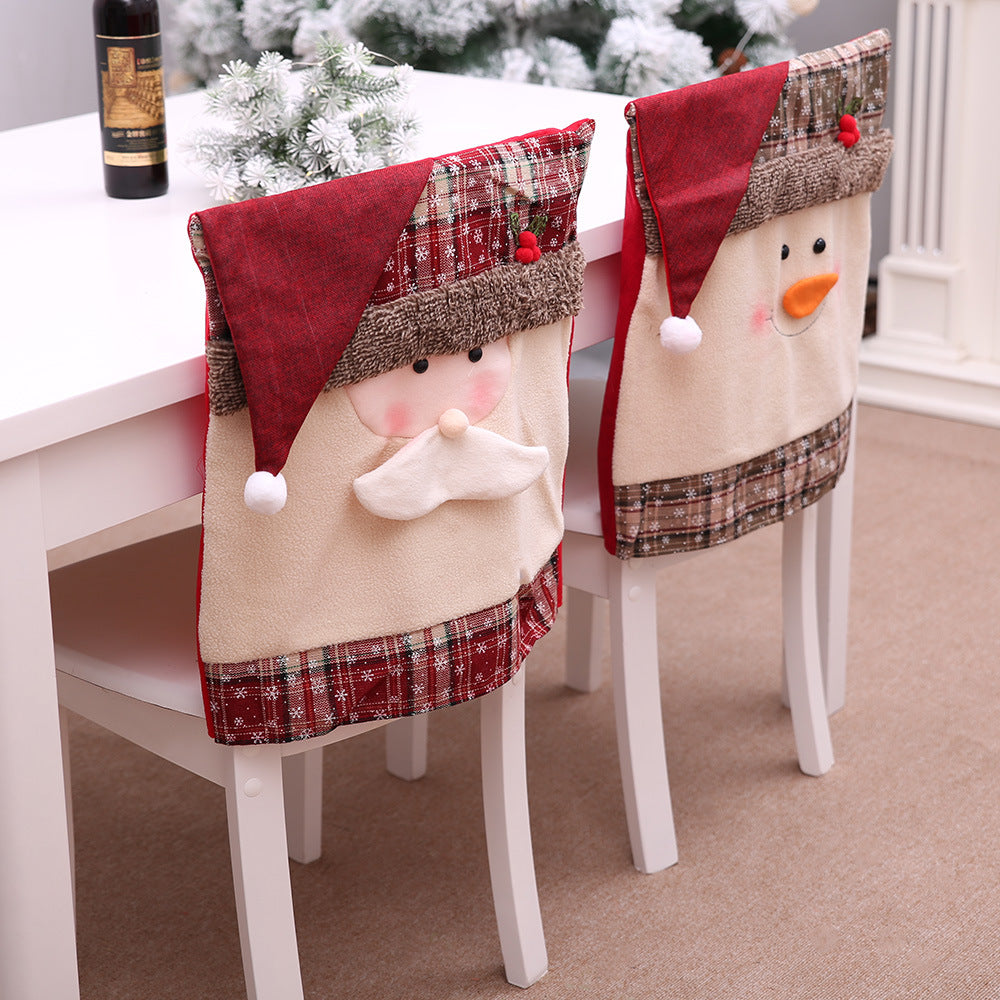 Festive Santa and Snowman chair covers with plaid trim and plush details for holiday dining.
