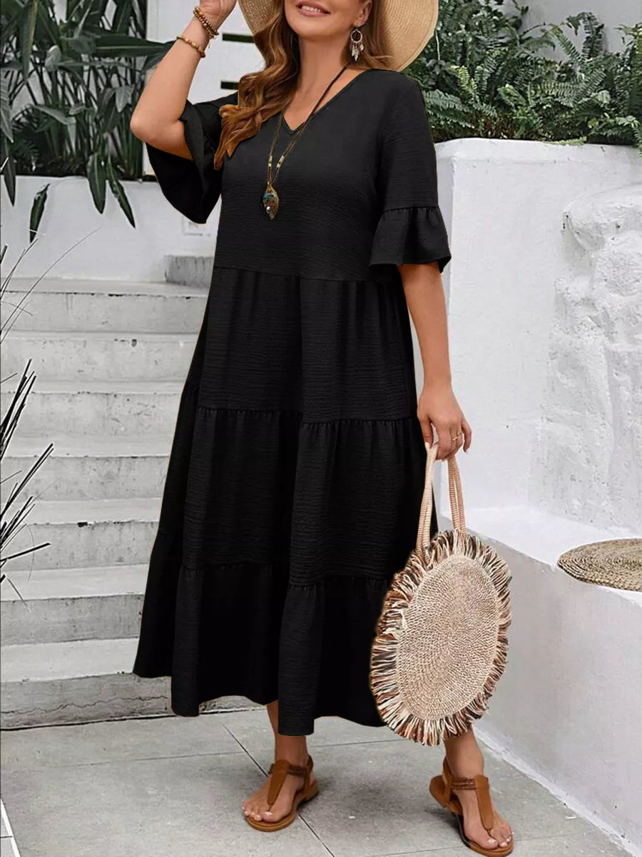 Black tiered midi dress with ruffle sleeves and V-neck, crinkled fabric