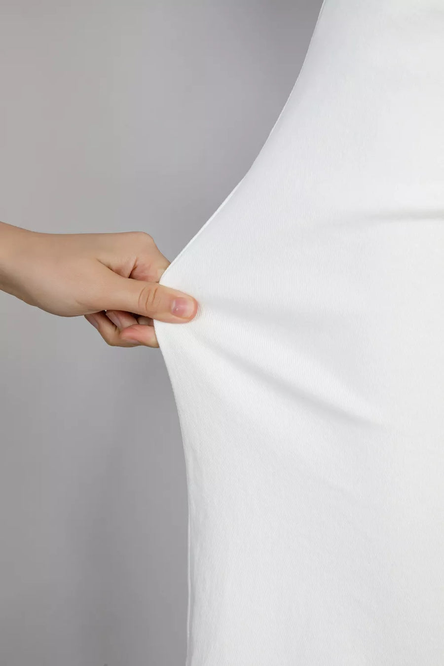 Casual white denim jeans showing fabric stretch