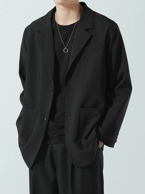 Black relaxed fit blazer with notch lapels and two button closure.
