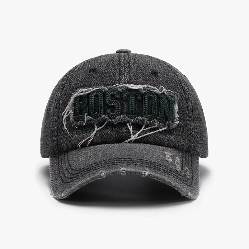 Distressed denim baseball cap in dark gray with embroidered Boston text and frayed details.