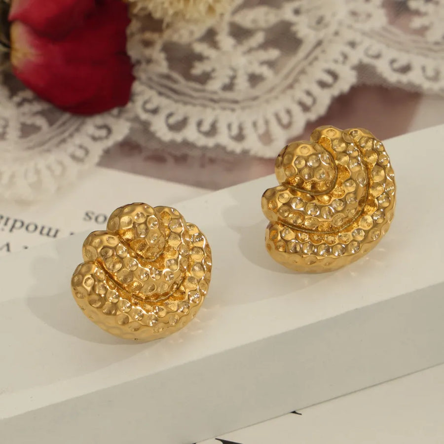 Textured shell stud earrings in gold with a hammered finish.