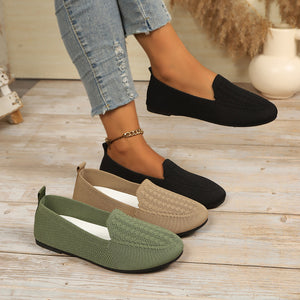 flats in black featuring breathable and slip-on fit