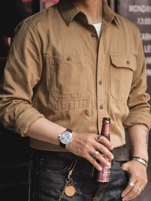 Khaki cotton twill utility shirt with two chest pockets and button front.