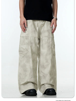 Relaxed fit beige cargo pants with multiple pockets and a tie-dye effect.