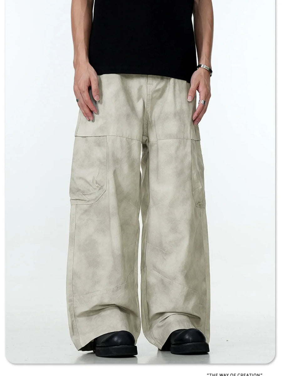 Relaxed fit beige cargo pants with multiple pockets and a tie-dye effect.