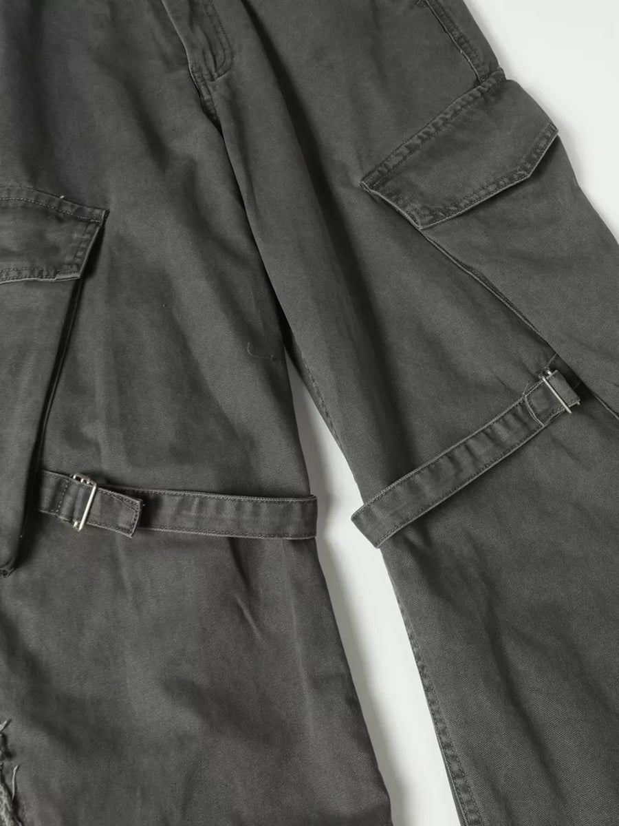 Grey cargo pants with buckle detail, multiple pockets, and distressed accents.