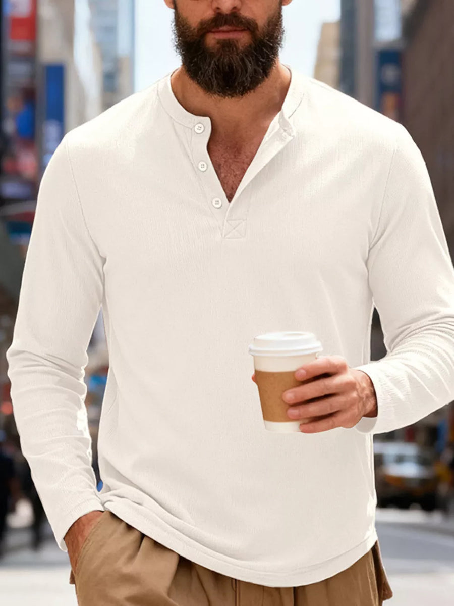 White long sleeve henley t-shirt with button placket and textured fabric.