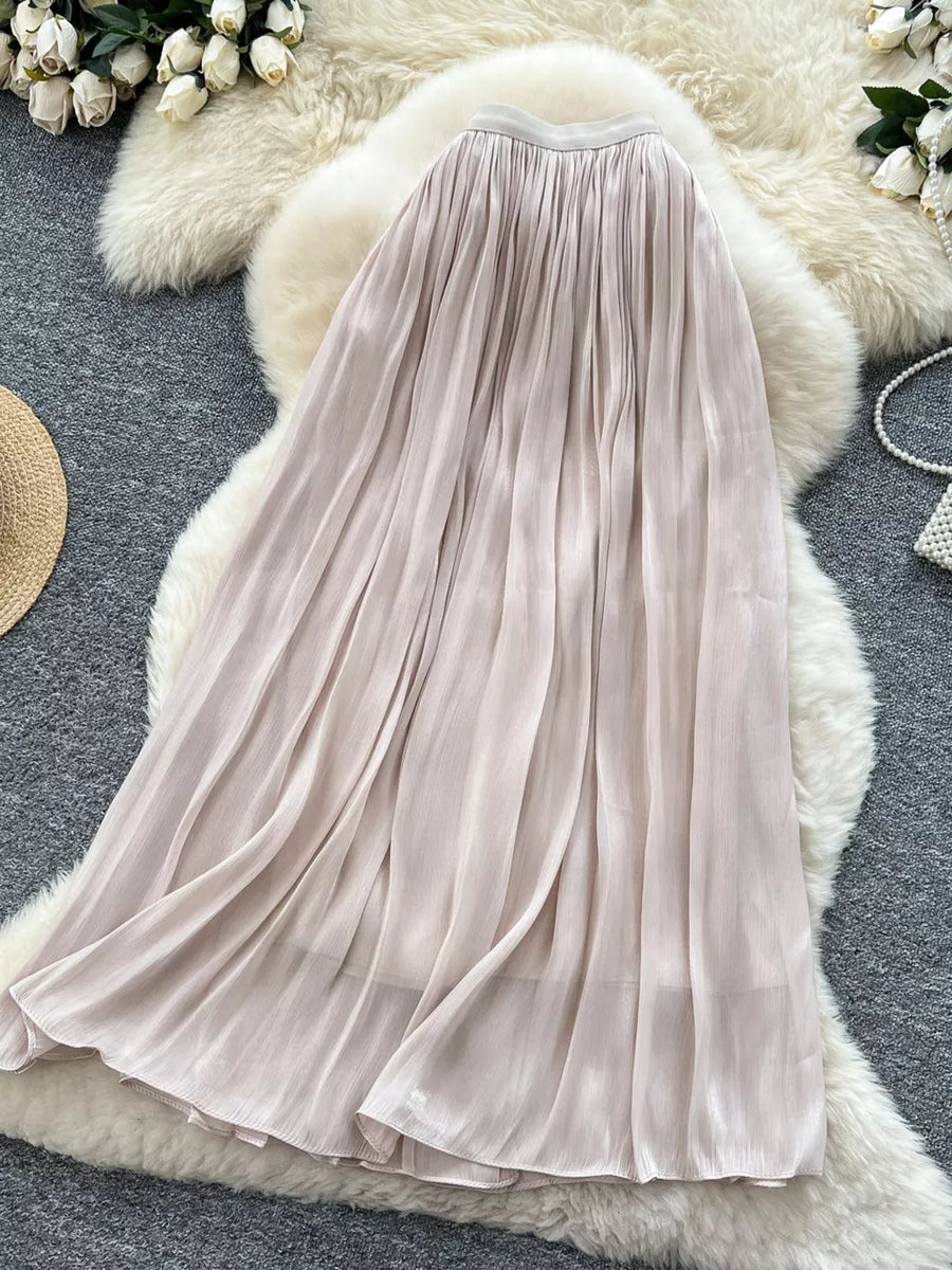 Pleated maxi skirt in cream with a flowing, elegant silhouette.