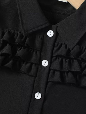 Black baby top with ruffled front and white buttons
