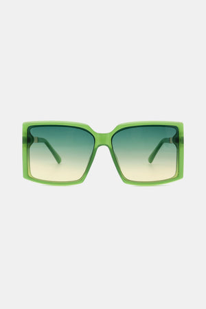 Green geometric sunglasses with gradient lenses and bold frames.