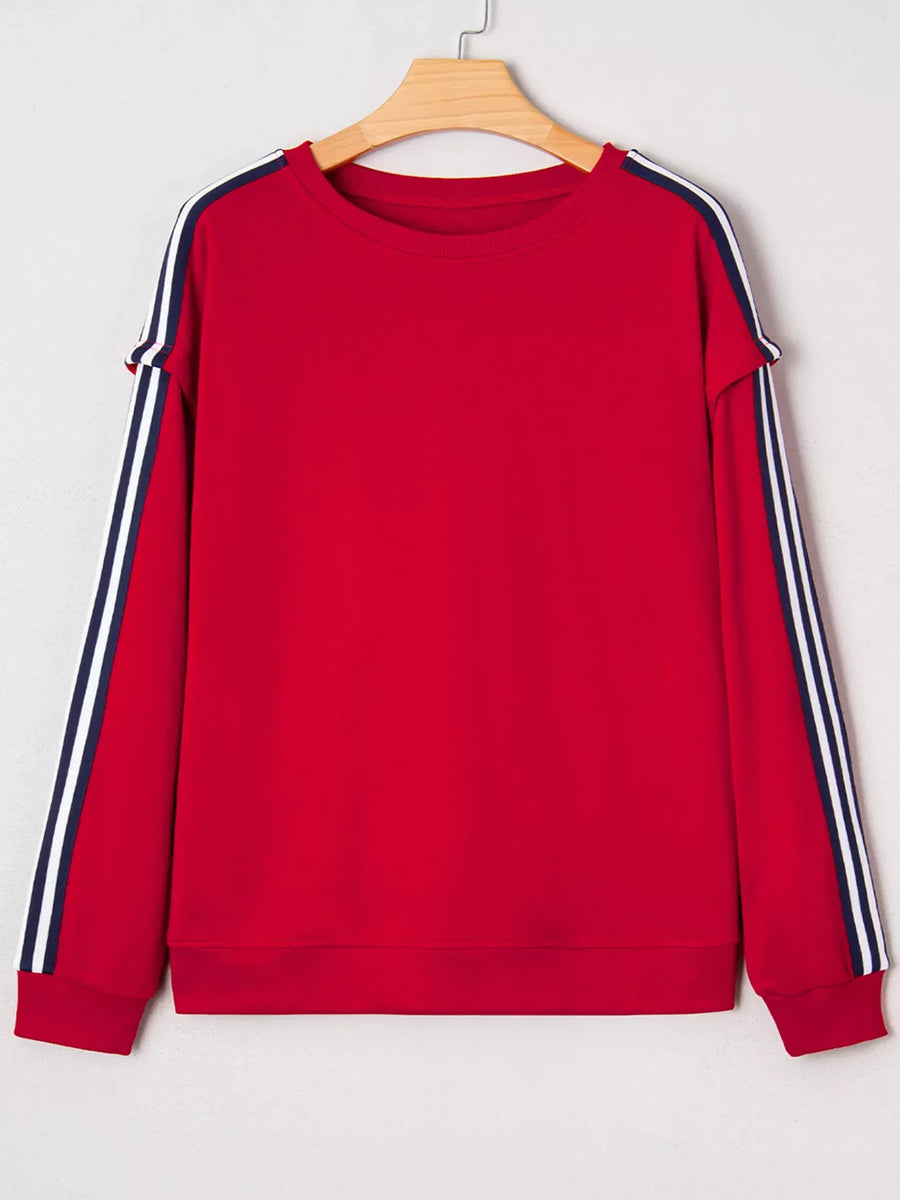 Red sweatshirt with varsity stripe detail on sleeves