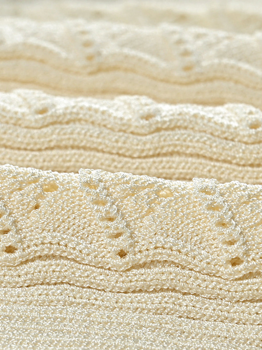 Ribbed knit maxi dress in pastel yellow with decorative button details.