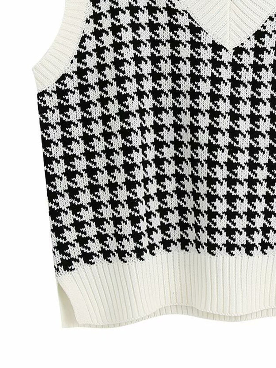 Houndstooth knit V-neck tank top in black and white with ribbed trim and side slits.