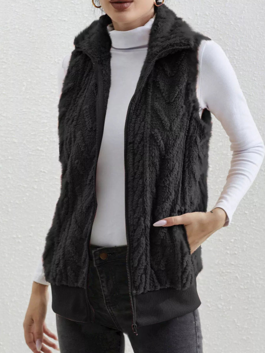 Black faux fur zip-up vest with textured pattern and pockets