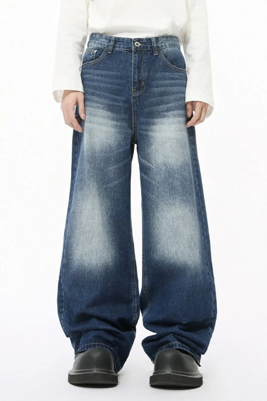 Faded wash balloon leg jeans in medium blue denim with a relaxed fit and wide leg.