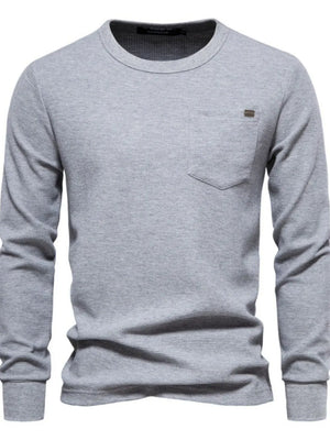 Gray textured thermal long sleeve tee with chest pocket and minimalist detail.