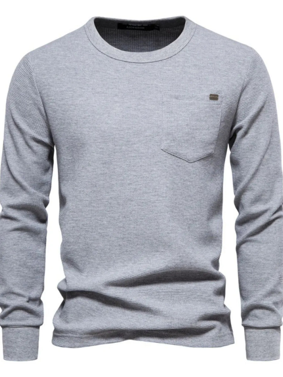 Gray textured thermal long sleeve tee with chest pocket and minimalist detail.