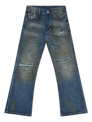 Distressed flare jeans in medium wash denim with patina effect and ripped details.