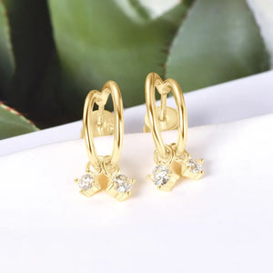 Gold cubic drop hoop earrings with clear cubic zirconia charms.