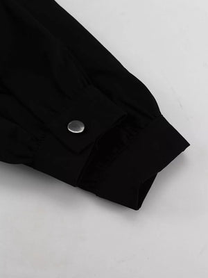 Black long sleeve shirt cuff with silver snap button detail