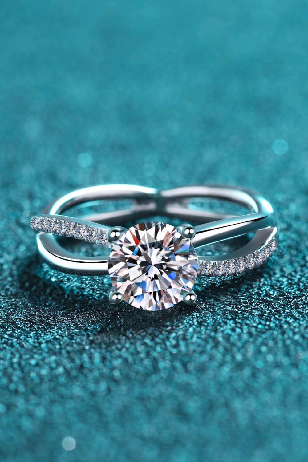 Silver crossover ring with solitaire moissanite and pavé band detail