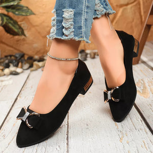 Black pointed-toe block heels with bow detail and gold accents