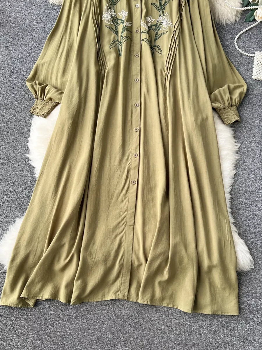 Khaki cotton maxi dress with embroidered floral detail and tie neck.