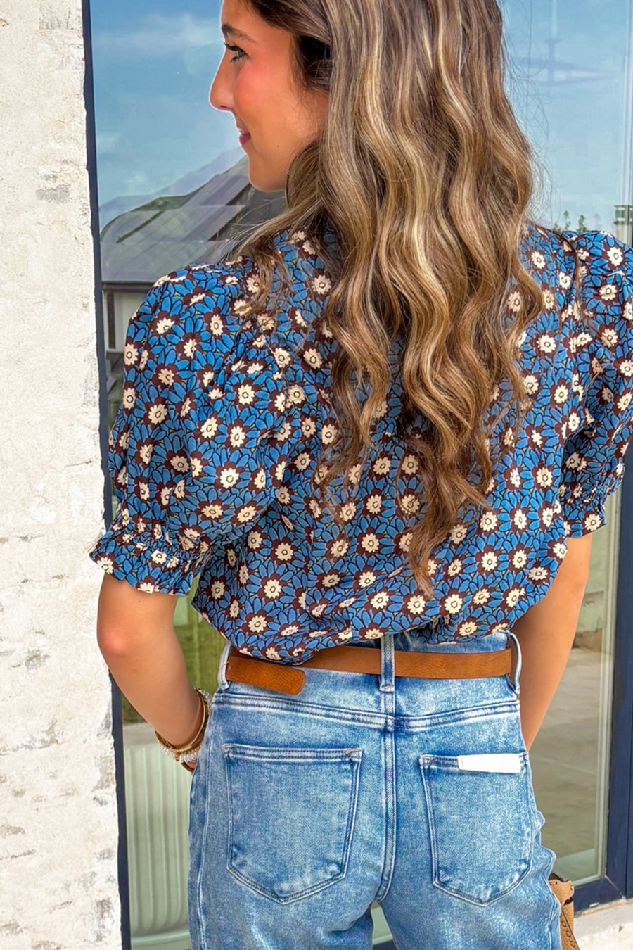 Blue floral cotton blouse with puff sleeves and ruffled cuffs.