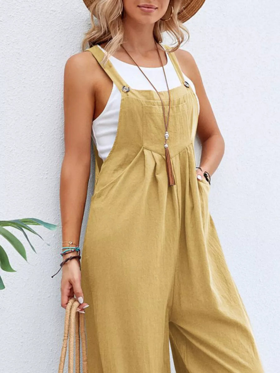 Light Yellow wide-leg romper with adjustable straps, button details, and pockets, styled with a white tank top.