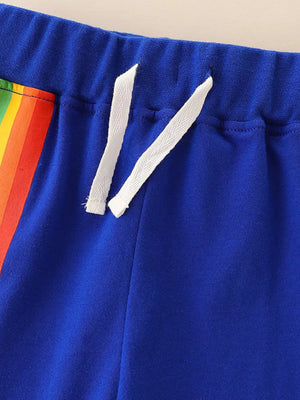Blue toddler shorts with rainbow stripe detail and white drawstring.