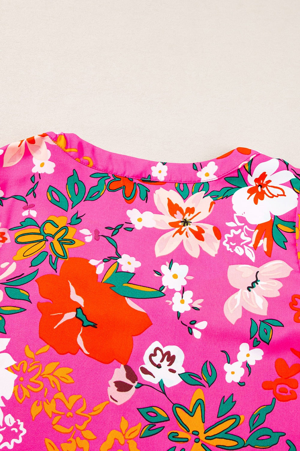 Hot pink floral print tunic with gathered sleeves and a crew neck.