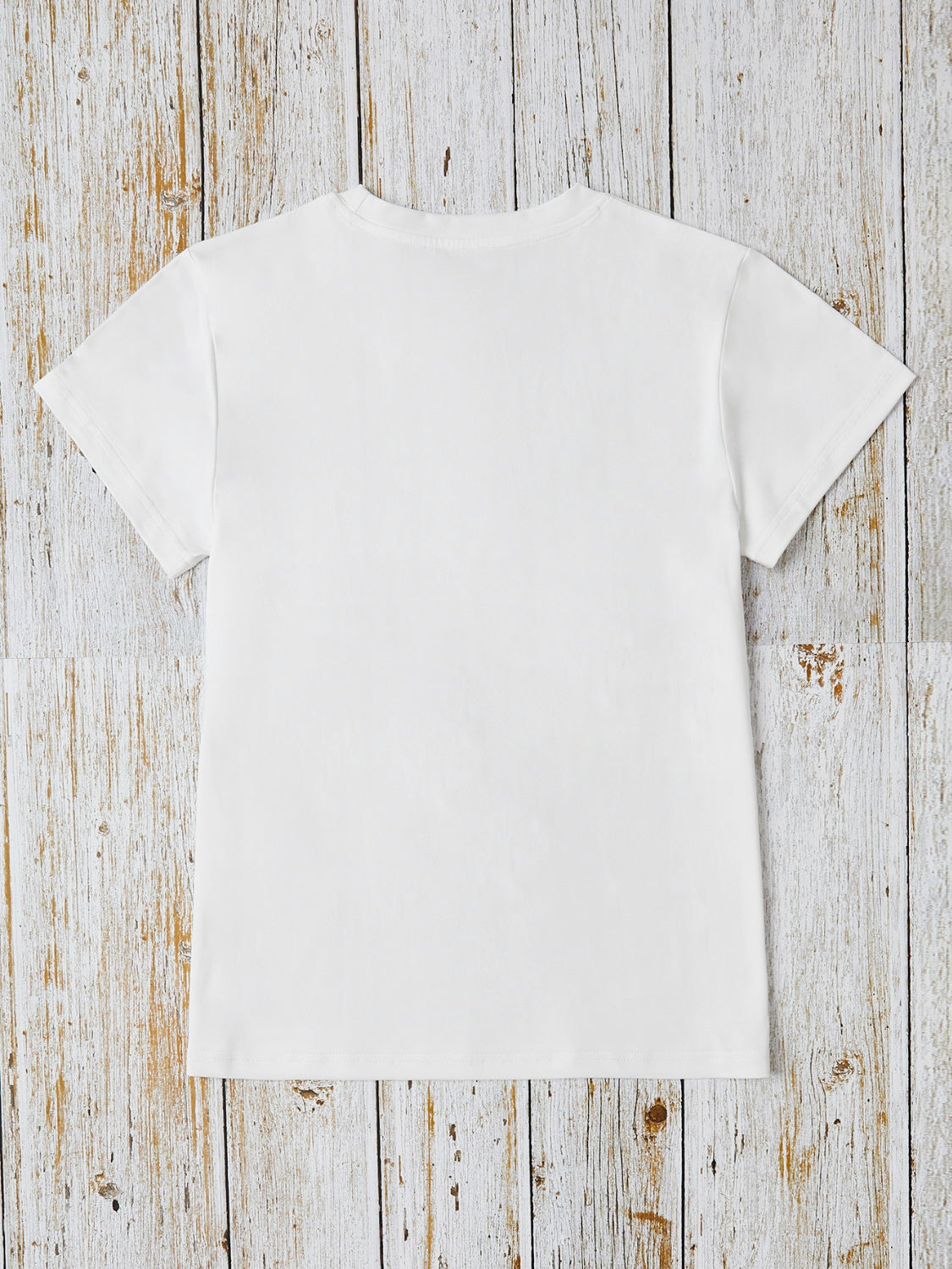White crew neck t-shirt with short sleeves and a relaxed fit.