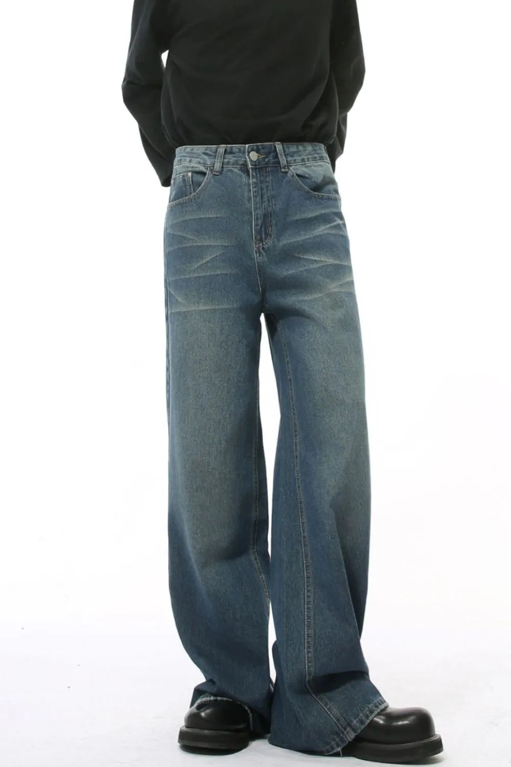 Wide leg vintage wash denim jeans in medium blue with a relaxed fit.