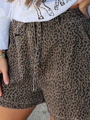 High-waisted denim shorts with a brown leopard print and a drawstring waist.
